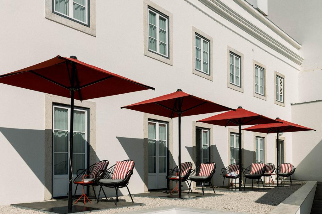Umbrellas and chairs in front of a Lisbon hotel