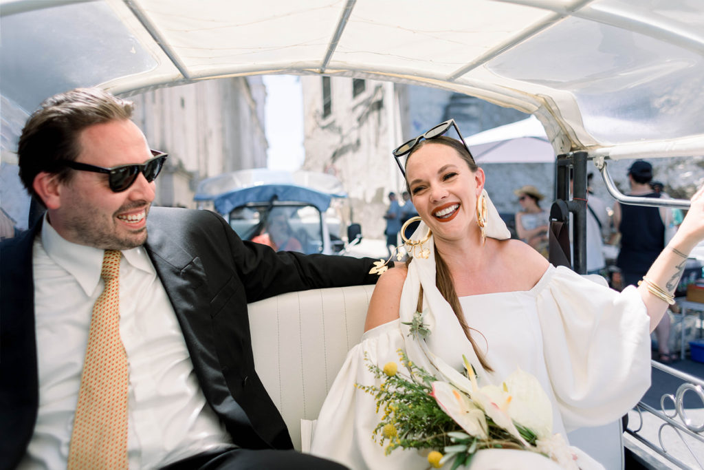 Bride and groom in a tuk-tuk in Lisbon