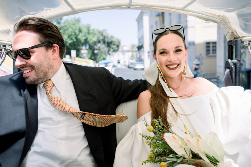 Bride and groom in a tuk-tuk in Lisbon