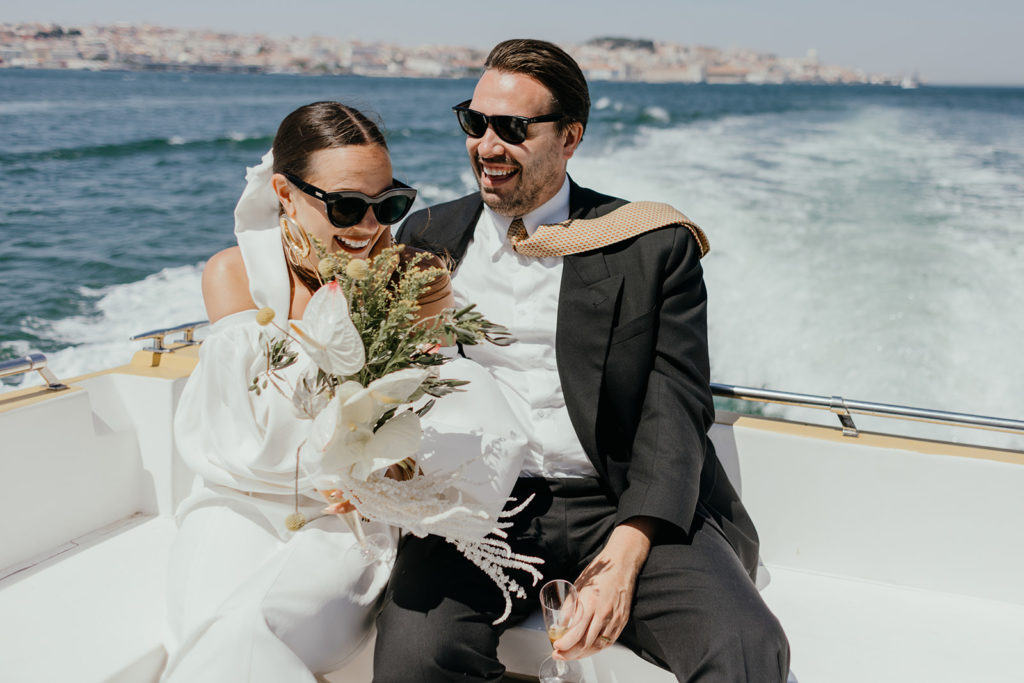 Bride and groom laughing on the boat
