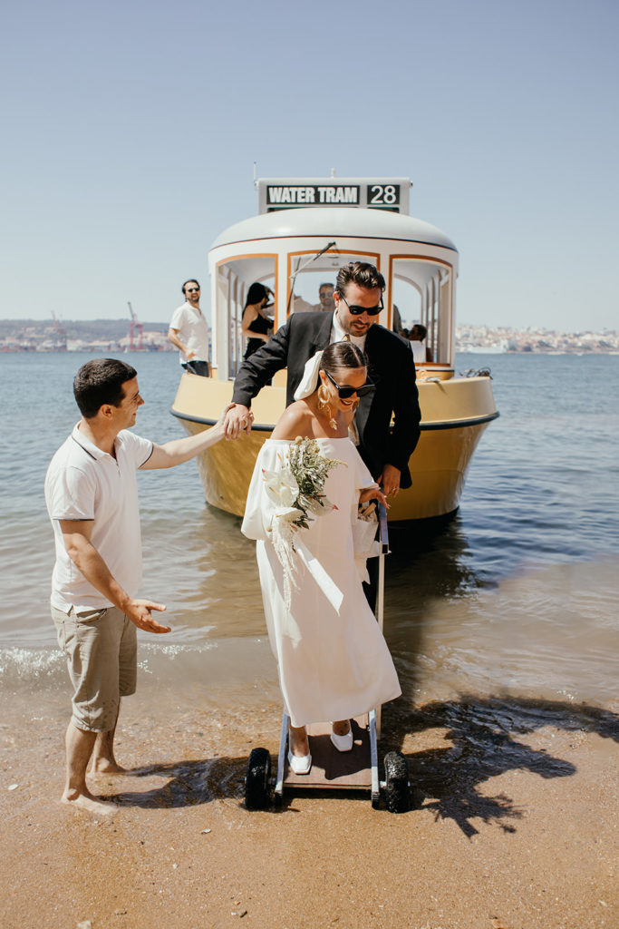Bride and groom getting of the boat at the Lisbon riverside