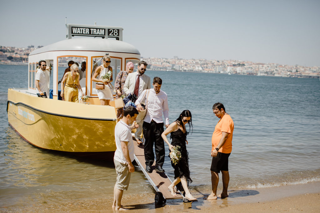 Wedding guests getting of the boat at the Lisbon riverside