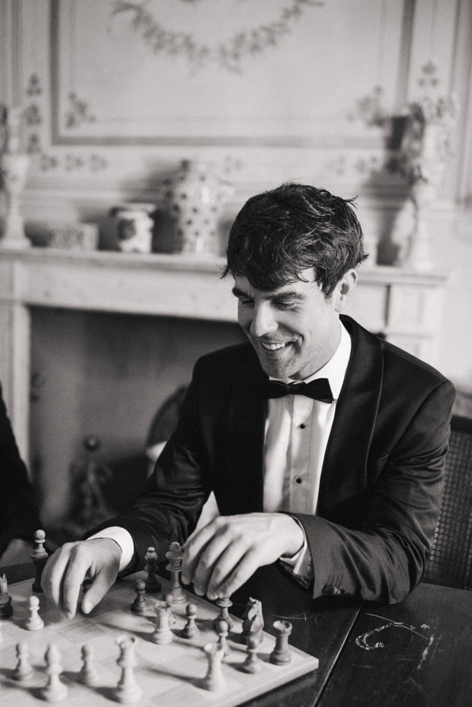 Groom playing chess with his father